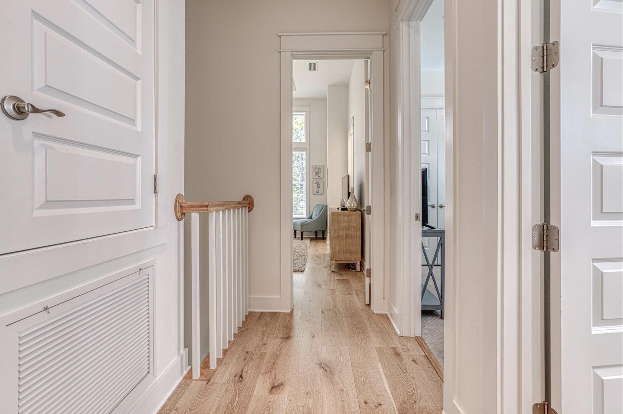 209 Milestone Dr Inlet Beach, Unit B Inlet Beach, FL 32461 - Photo 30 of 39 a view of a hallway with wooden floor and closet area