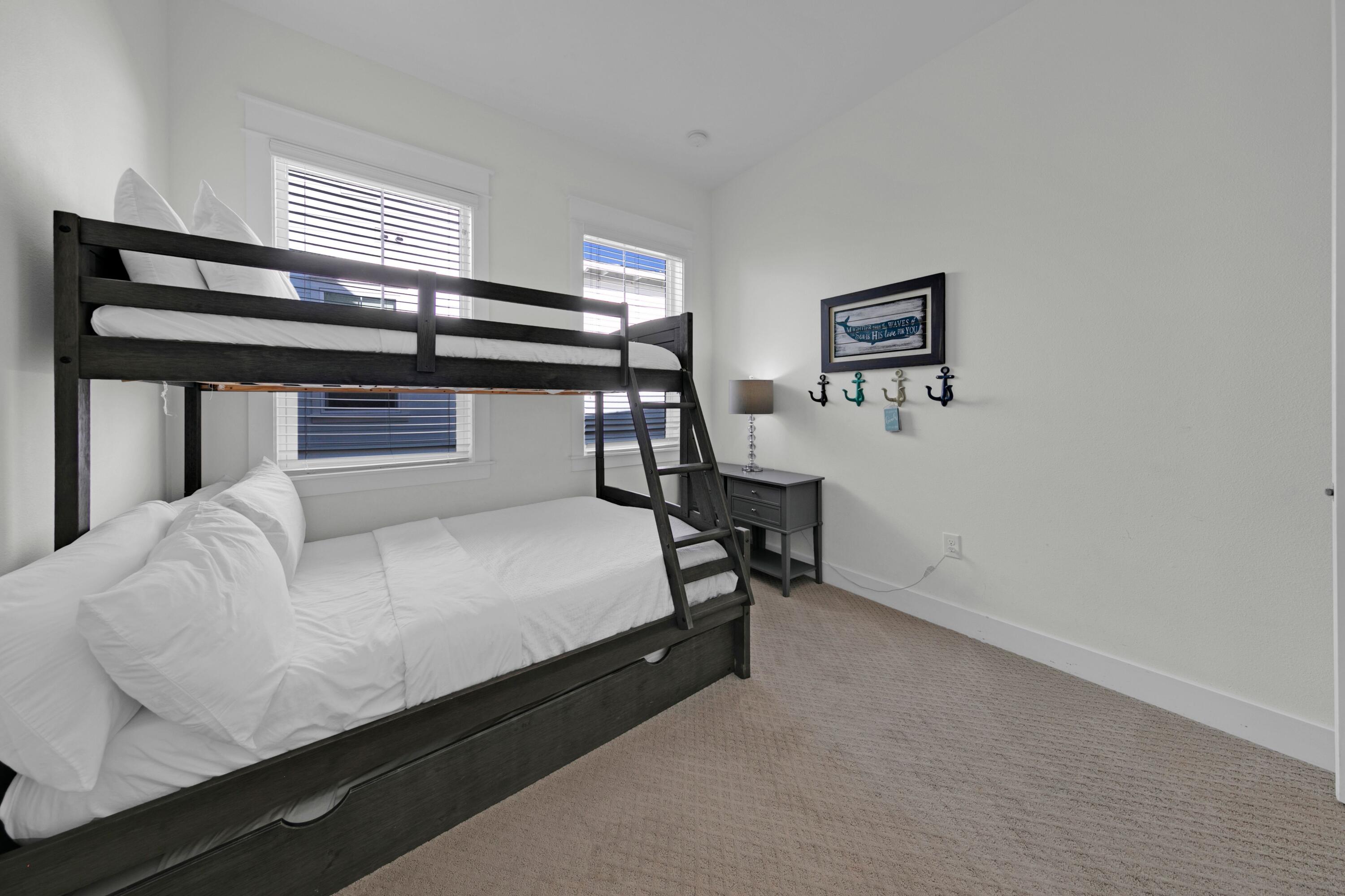 209 Milestone Dr Inlet Beach, Unit B Inlet Beach, FL 32461 - Photo 36 of 39 a bed room with a bed and paintings on the wall