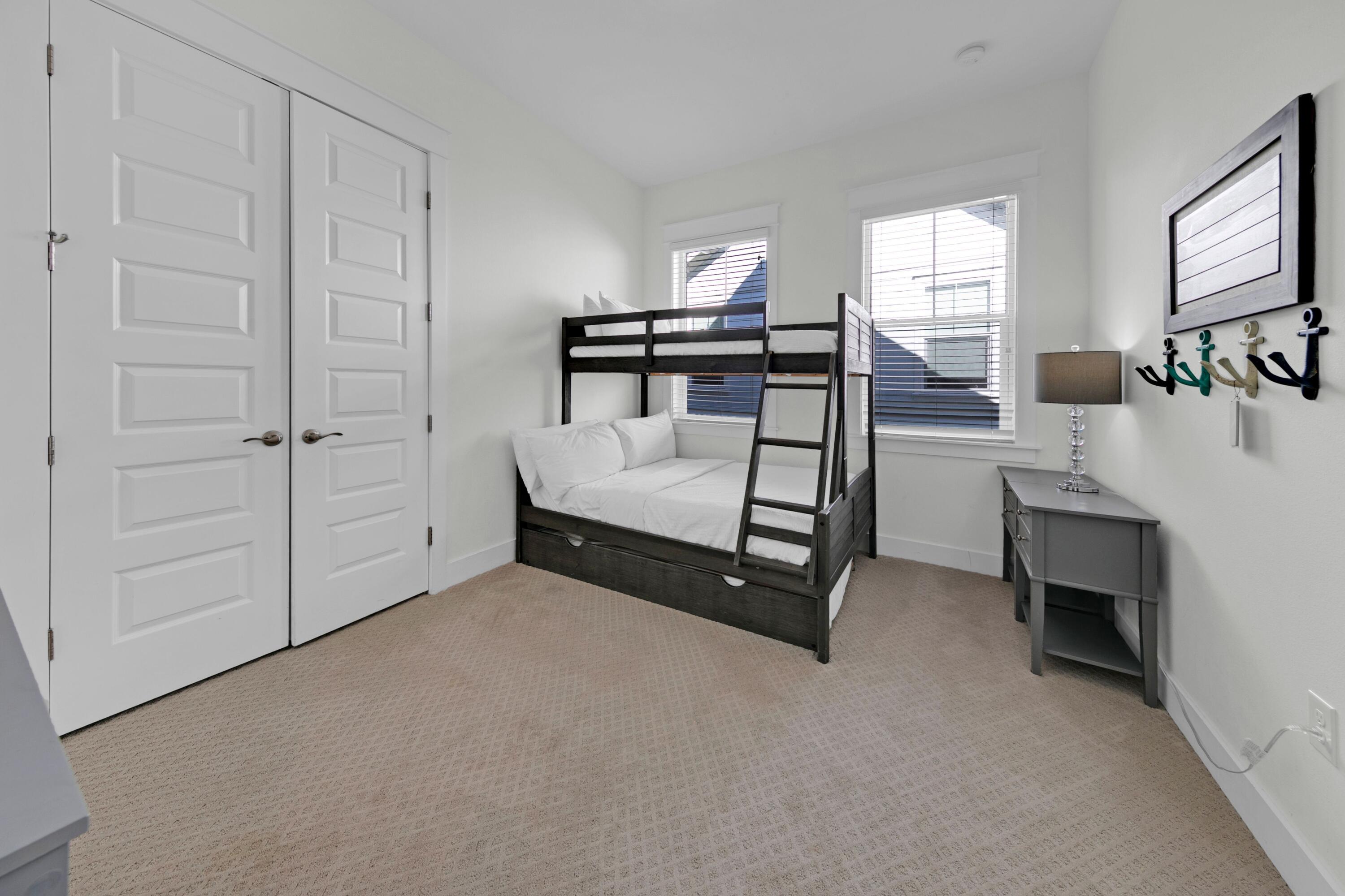 209 Milestone Dr Inlet Beach, Unit B Inlet Beach, FL 32461 - Photo 37 of 39 a spacious bedroom with a bed and a cabinets