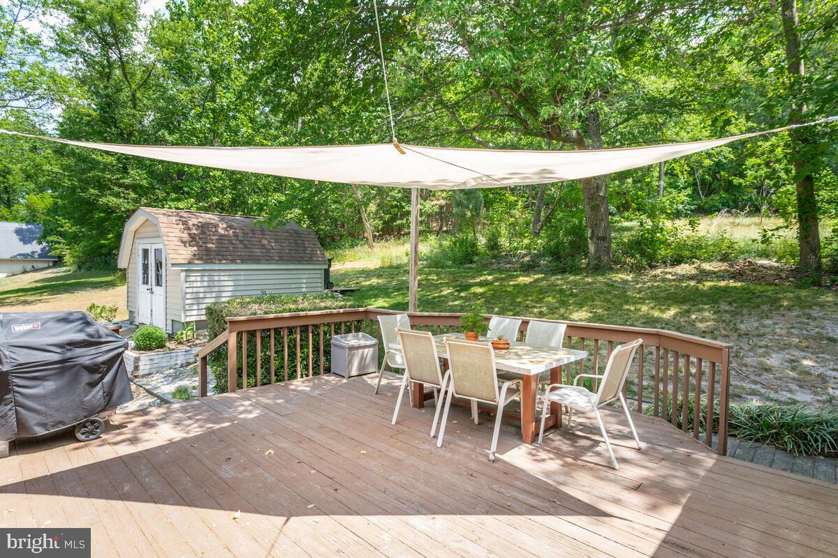 1260 Coster Road Lusby, MD 20657 - Photo 41 of 46 a patio with water view fountain and wooden fence