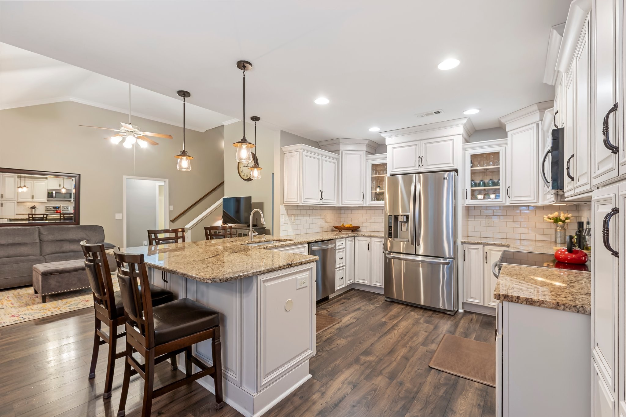 a kitchen with refrigerator cabinets dining table and chairs