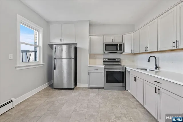 a kitchen with a refrigerator stove and microwave