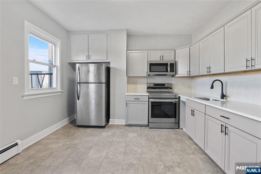 a kitchen with a refrigerator stove and microwave