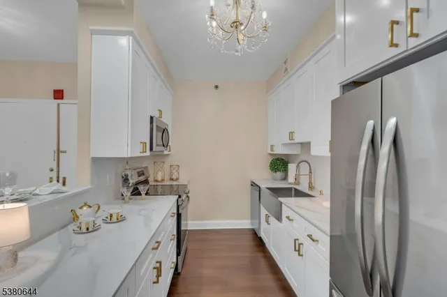 a kitchen with kitchen island granite countertop a sink appliances cabinets and counter space