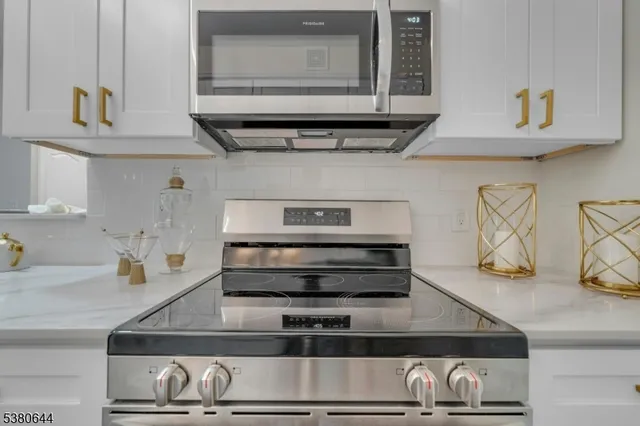 a view of a hallway with wooden floor and cabinet