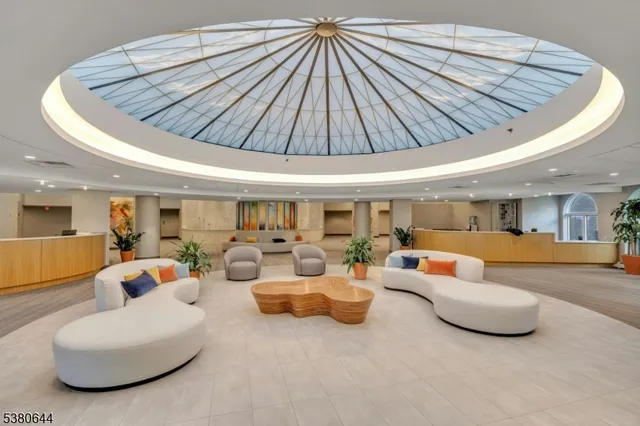 a view of a livingroom with furniture a fireplace and wooden floor
