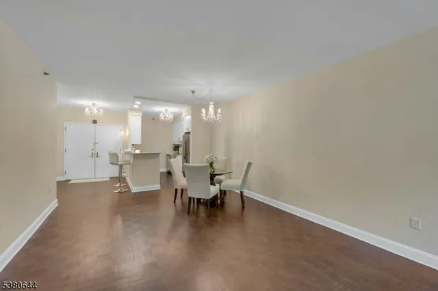 a view of a dining room with furniture and chandelier