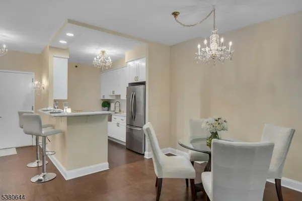 a kitchen with kitchen island granite countertop a sink cabinets a refrigerator and a stove
