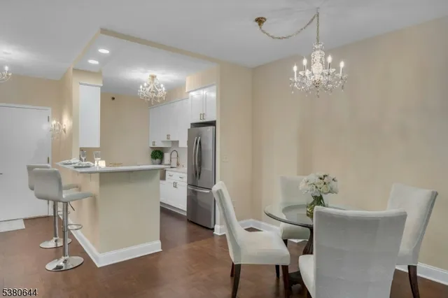 a kitchen with kitchen island granite countertop a sink cabinets a refrigerator and a stove