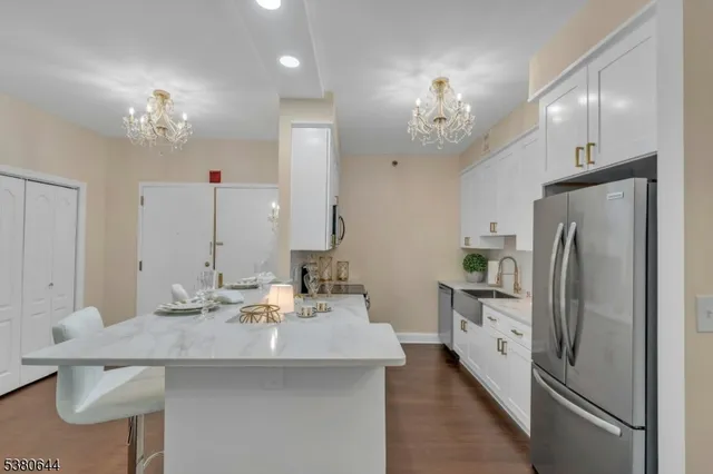 a view of a dining room with furniture and chandelier