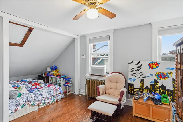 a living room with baby toys and a wooden floor