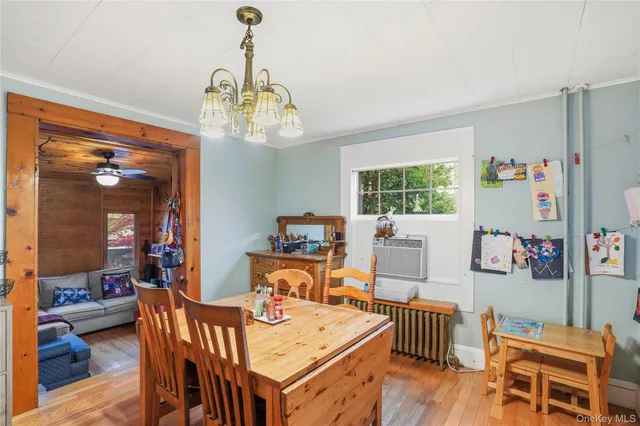 a view of a dining room with furniture and a chandelier