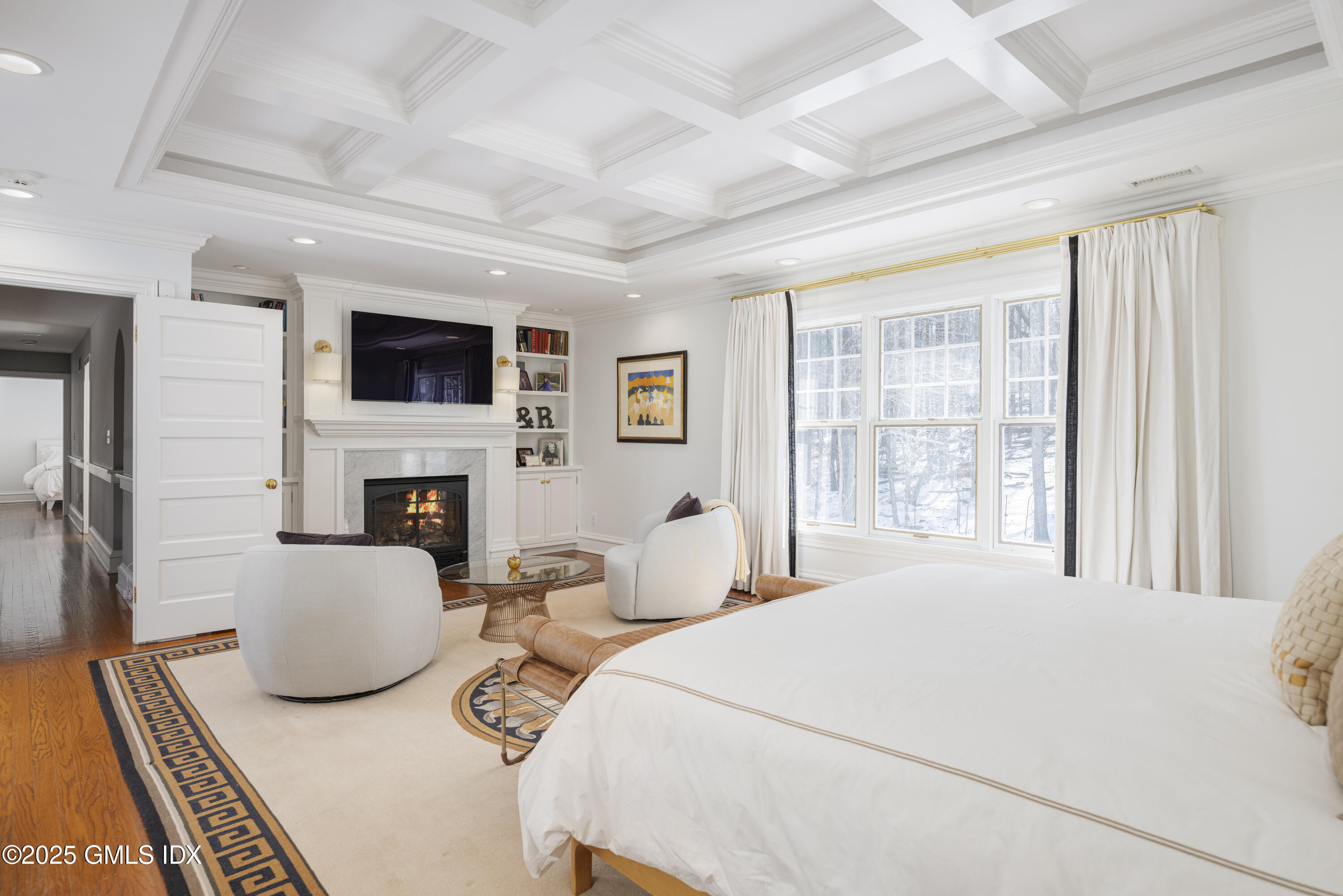 44 North Porchuck Road Greenwich, CT 06831 - Photo 21 of 61 a bedroom with furniture a flat screen tv and a fireplace