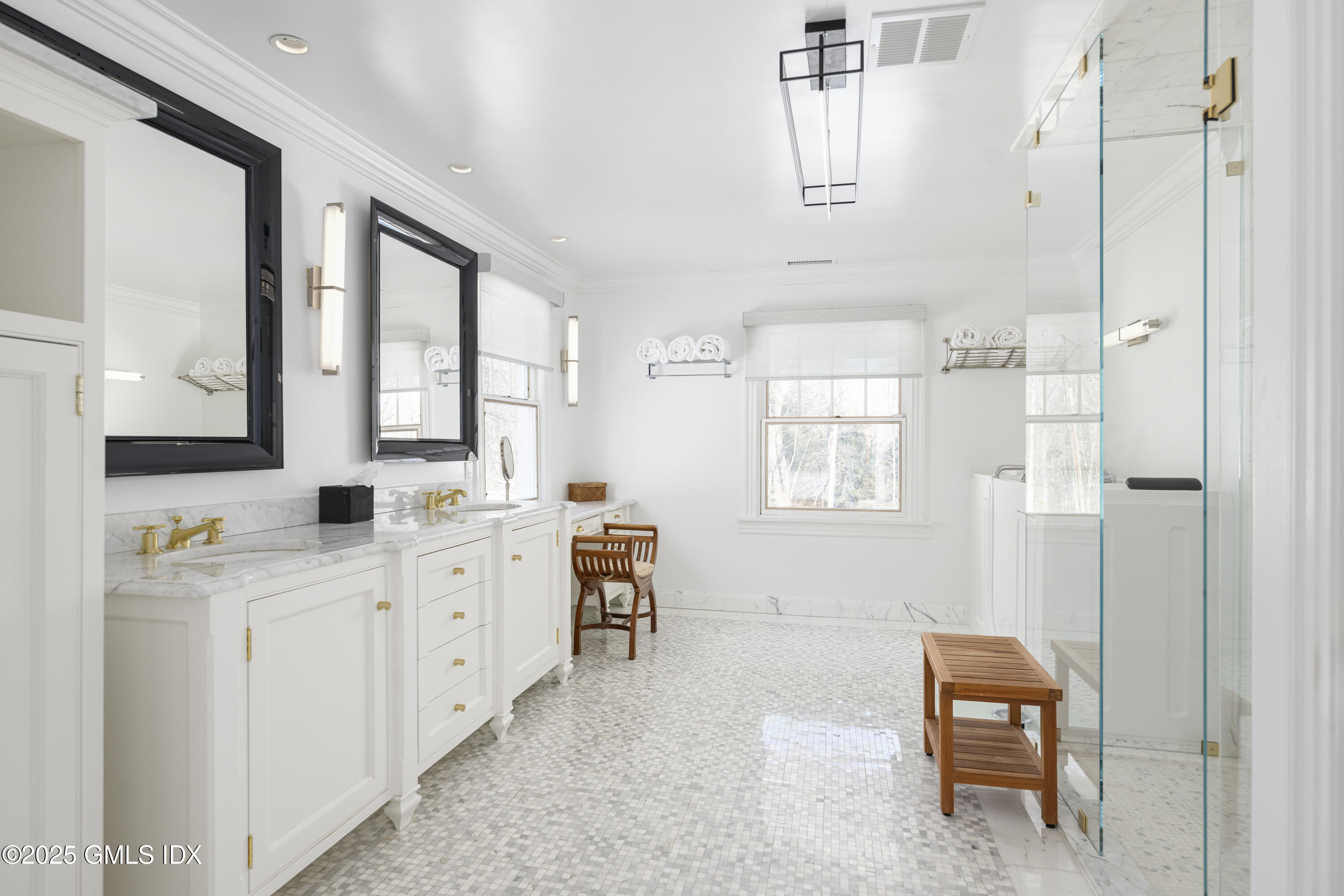 44 North Porchuck Road Greenwich, CT 06831 - Photo 22 of 61 a bathroom with a double vanity sink a toilet a mirror and next to a window