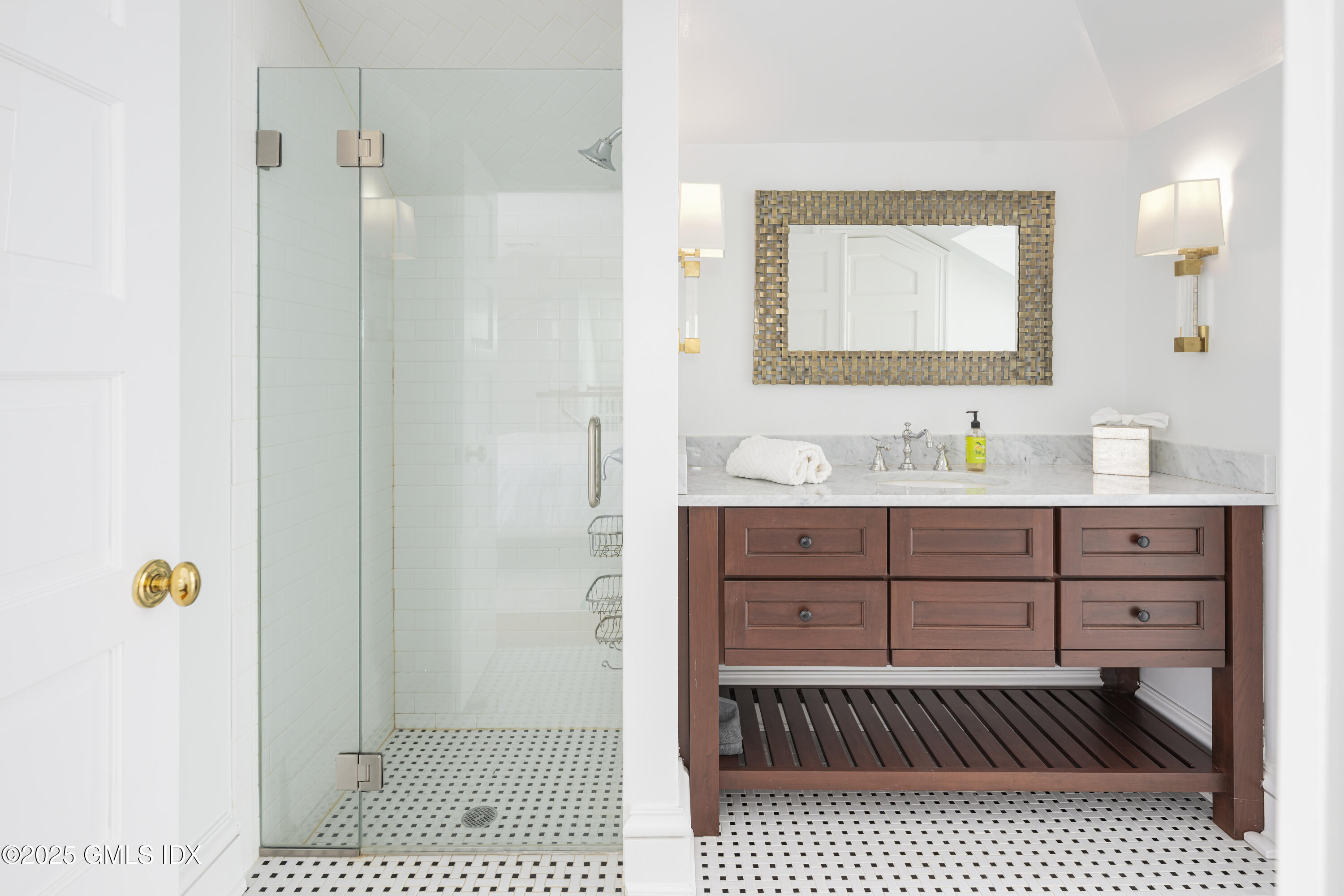 44 North Porchuck Road Greenwich, CT 06831 - Photo 33 of 61 a bathroom with a sink a mirror and a shower