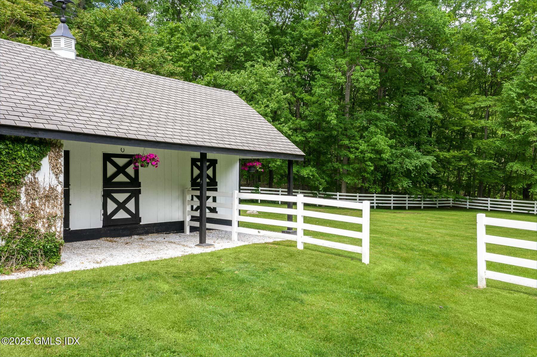 44 North Porchuck Road Greenwich, CT 06831 - Photo 51 of 61 a view of a house with a backyard