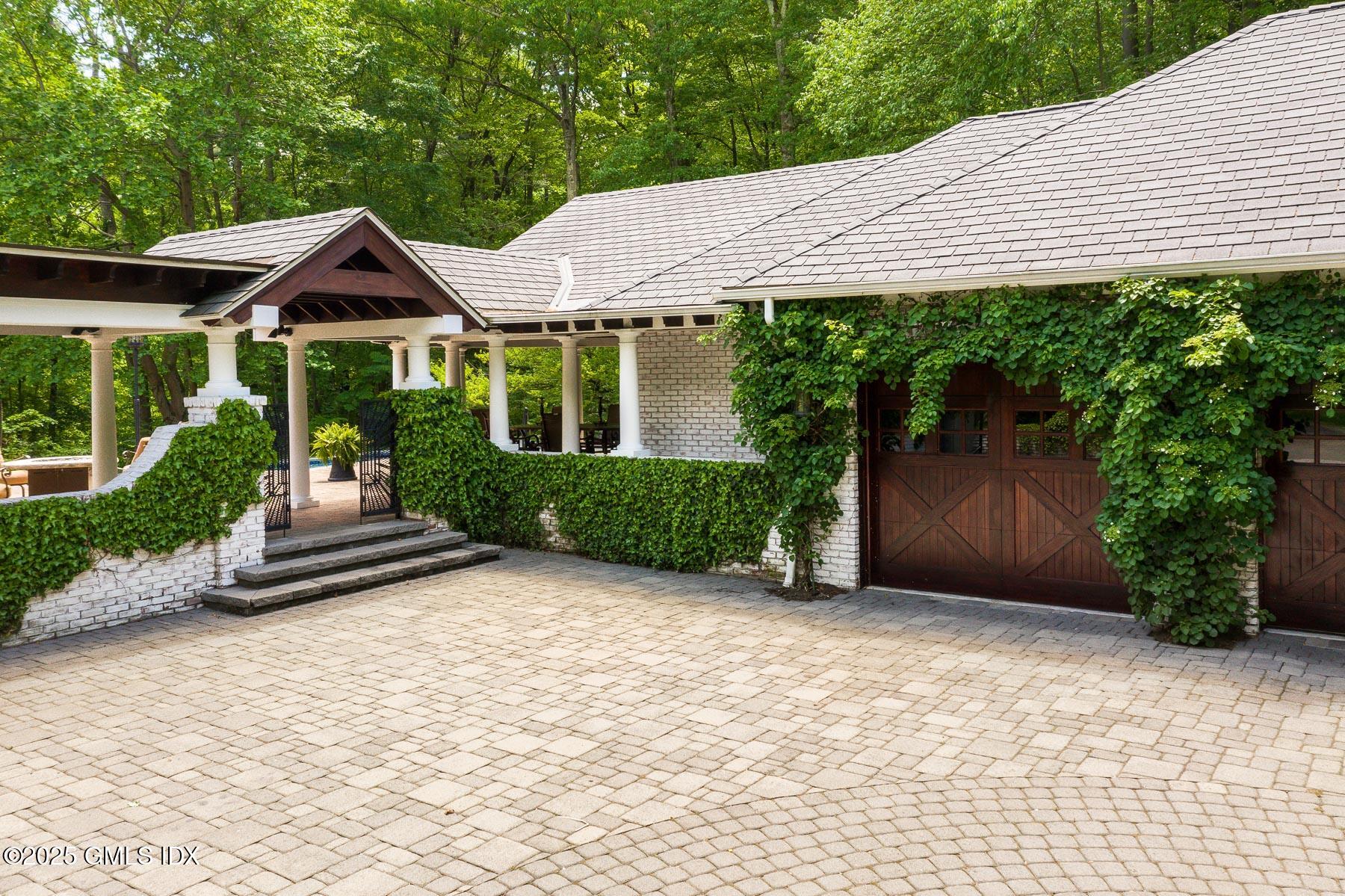 44 North Porchuck Road Greenwich, CT 06831 - Photo 57 of 61 a front view of a house with garden