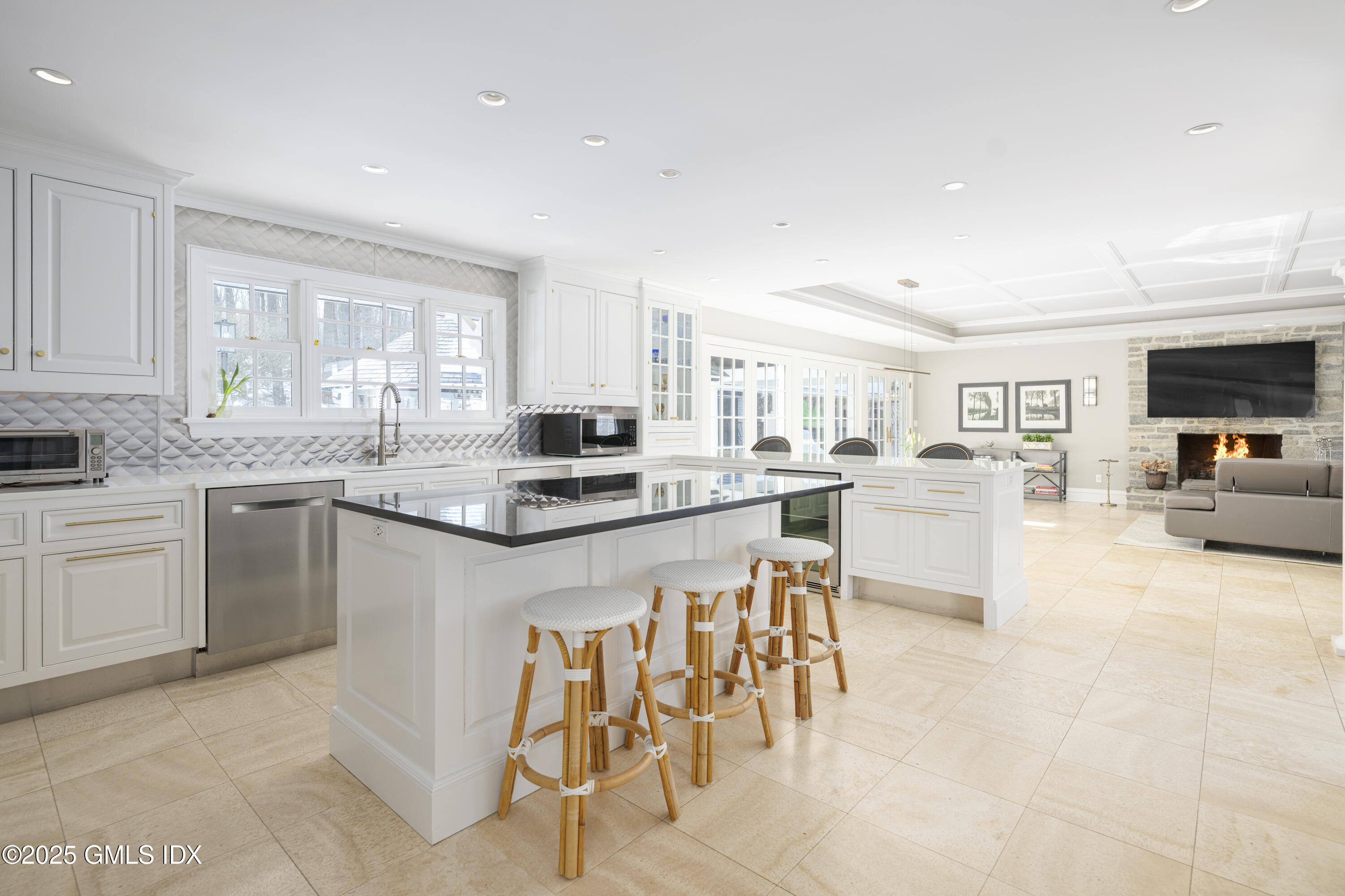 44 North Porchuck Road Greenwich, CT 06831 - Photo 9 of 61 a kitchen with stainless steel appliances kitchen island granite countertop a stove top oven a sink a dining table and chairs