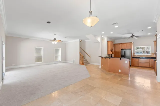 a kitchen with granite countertop white cabinets stainless steel appliances and a sink