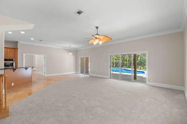 a large kitchen with a sink and dishwasher a stove with wooden floor