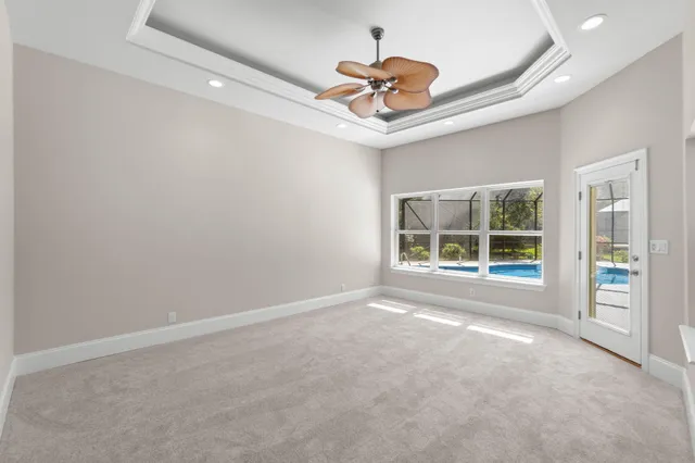 an aerial view of a house with a garden and lake view