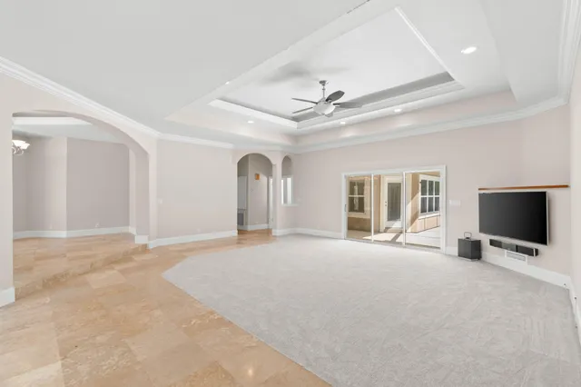 a view of a living room and kitchen with a chandelier