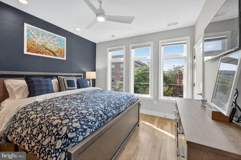 a bed sitting in a bedroom next to a window