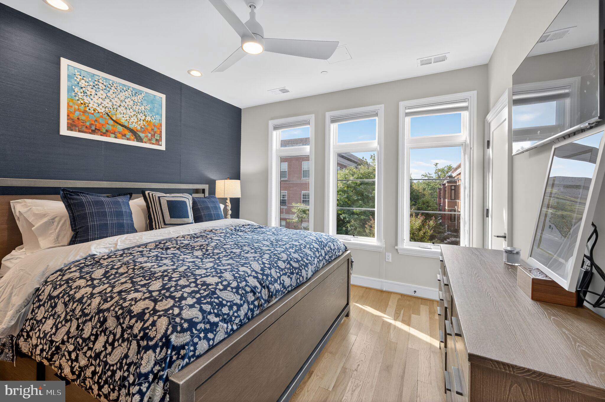 1309 D Street Southeast Washington, DC 20003 - Photo 15 of 38 a bed sitting in a bedroom next to a window