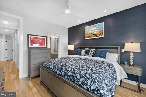 a bedroom with bed and wooden floor