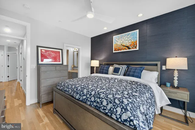 a bedroom with bed and wooden floor