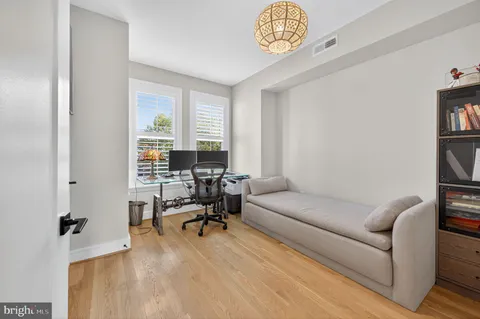 a living room with furniture a rug and a window