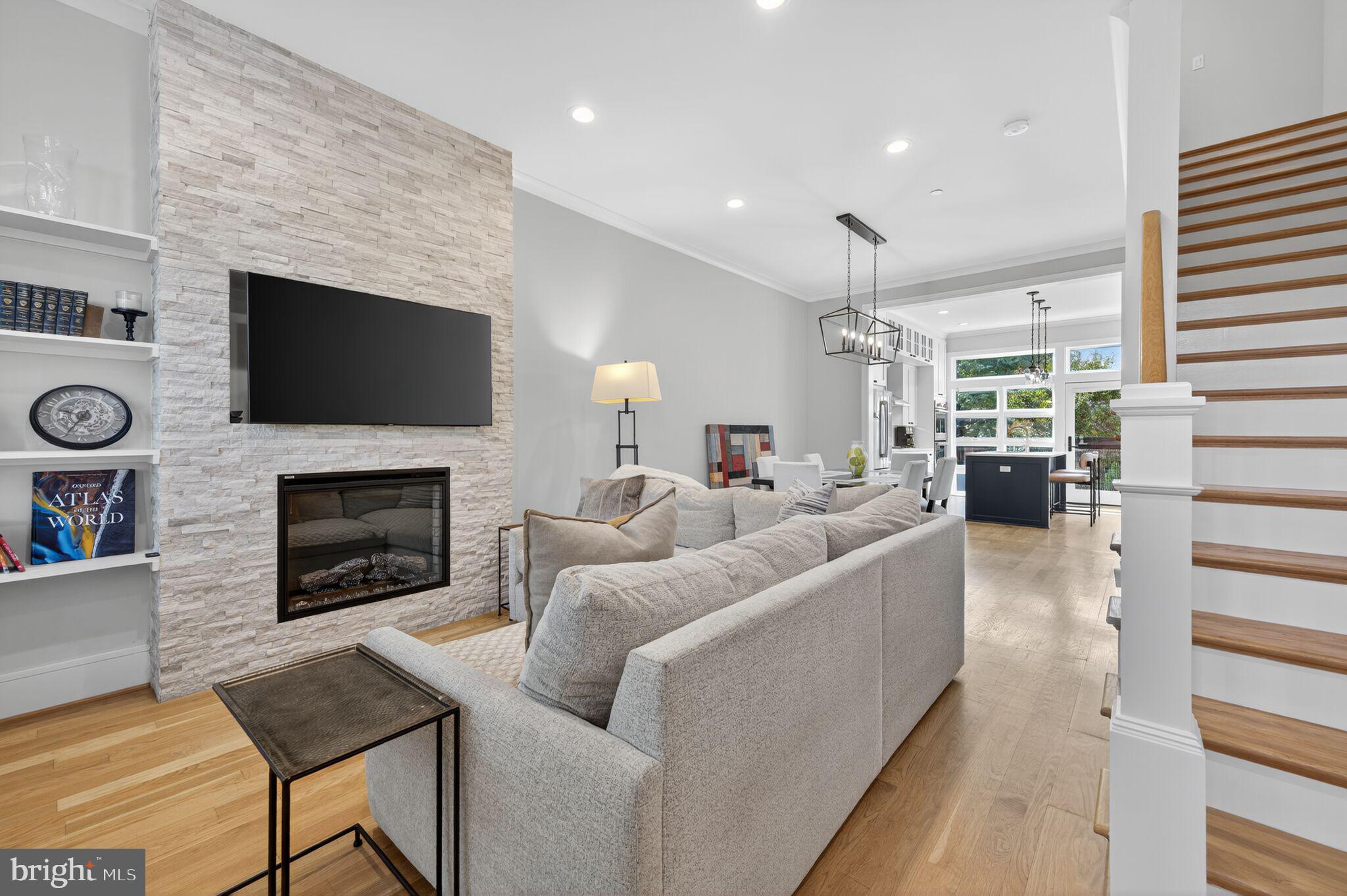 1309 D Street Southeast Washington, DC 20003 - Photo 2 of 38 a living room with furniture a fireplace and a flat screen tv