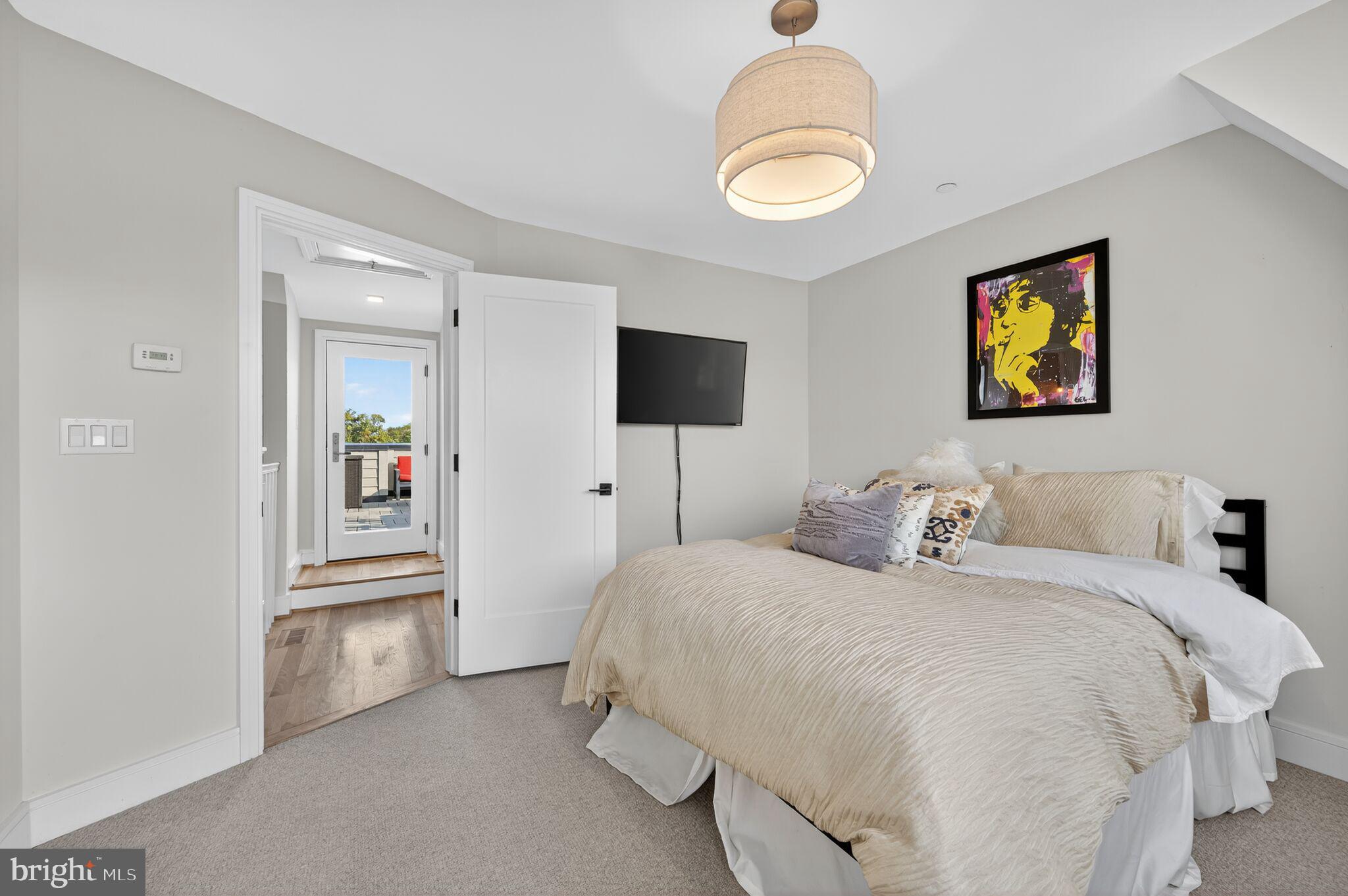 1309 D Street Southeast Washington, DC 20003 - Photo 23 of 38 a bedroom with a bed and a chandelier