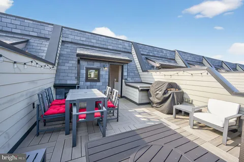 a view of a deck with wooden floor and furniture