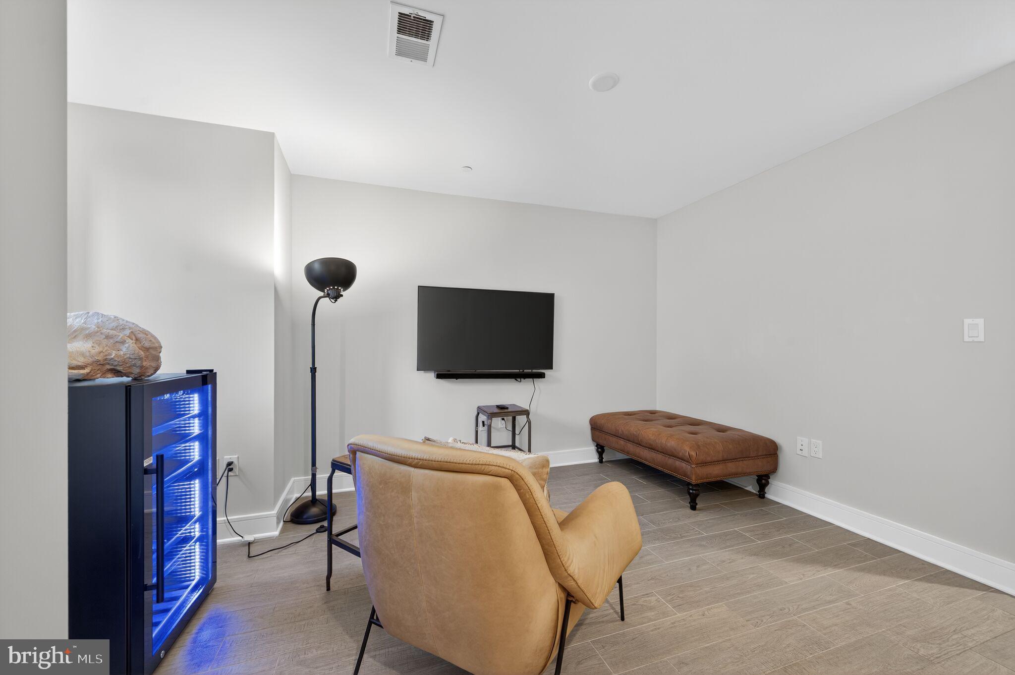 1309 D Street Southeast Washington, DC 20003 - Photo 27 of 38 a living room with furniture and a flat screen tv