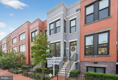 a view of a brick building next to a yard