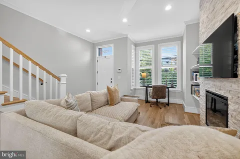 a living room with furniture flat screen tv and a fireplace
