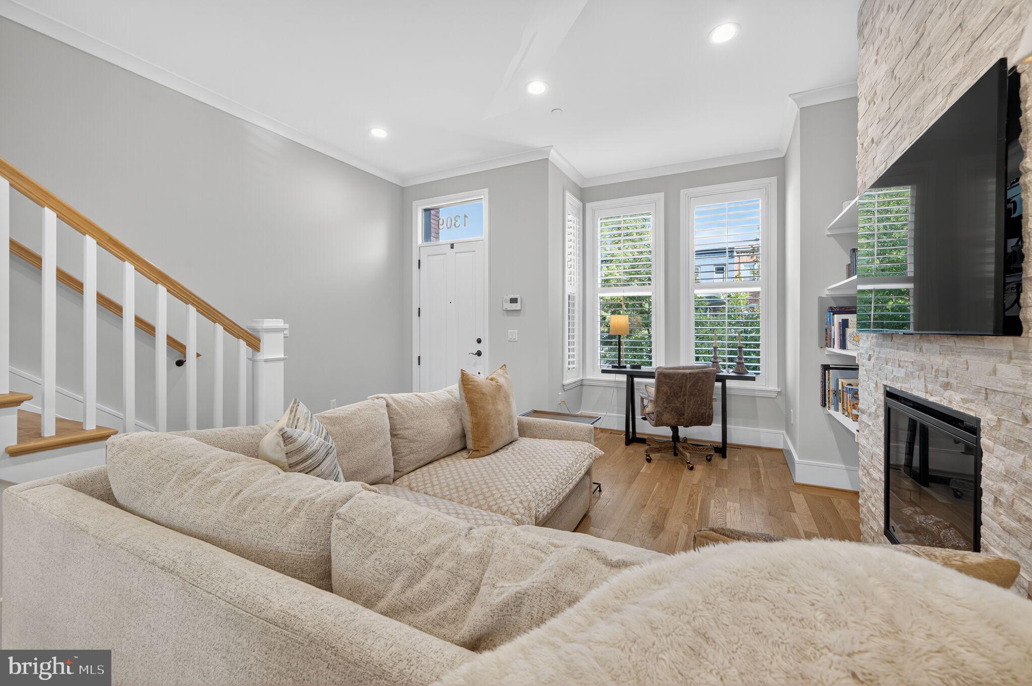 1309 D Street Southeast Washington, DC 20003 - Photo 5 of 38 a living room with furniture flat screen tv and a fireplace