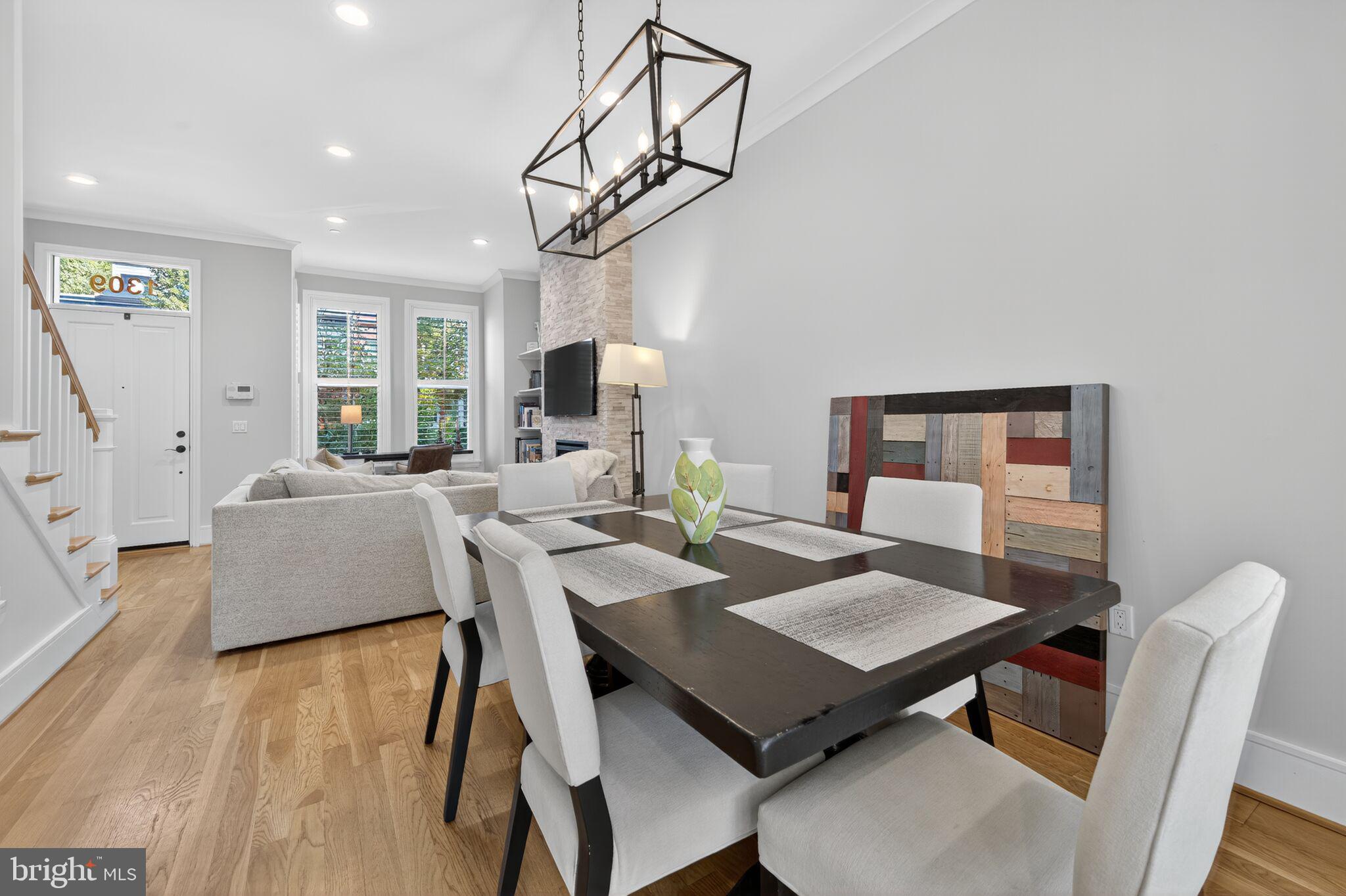 1309 D Street Southeast Washington, DC 20003 - Photo 7 of 38 a view of a dining room with furniture a chandelier and wooden floor