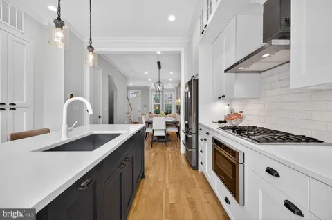 a kitchen with a sink stove and cabinets