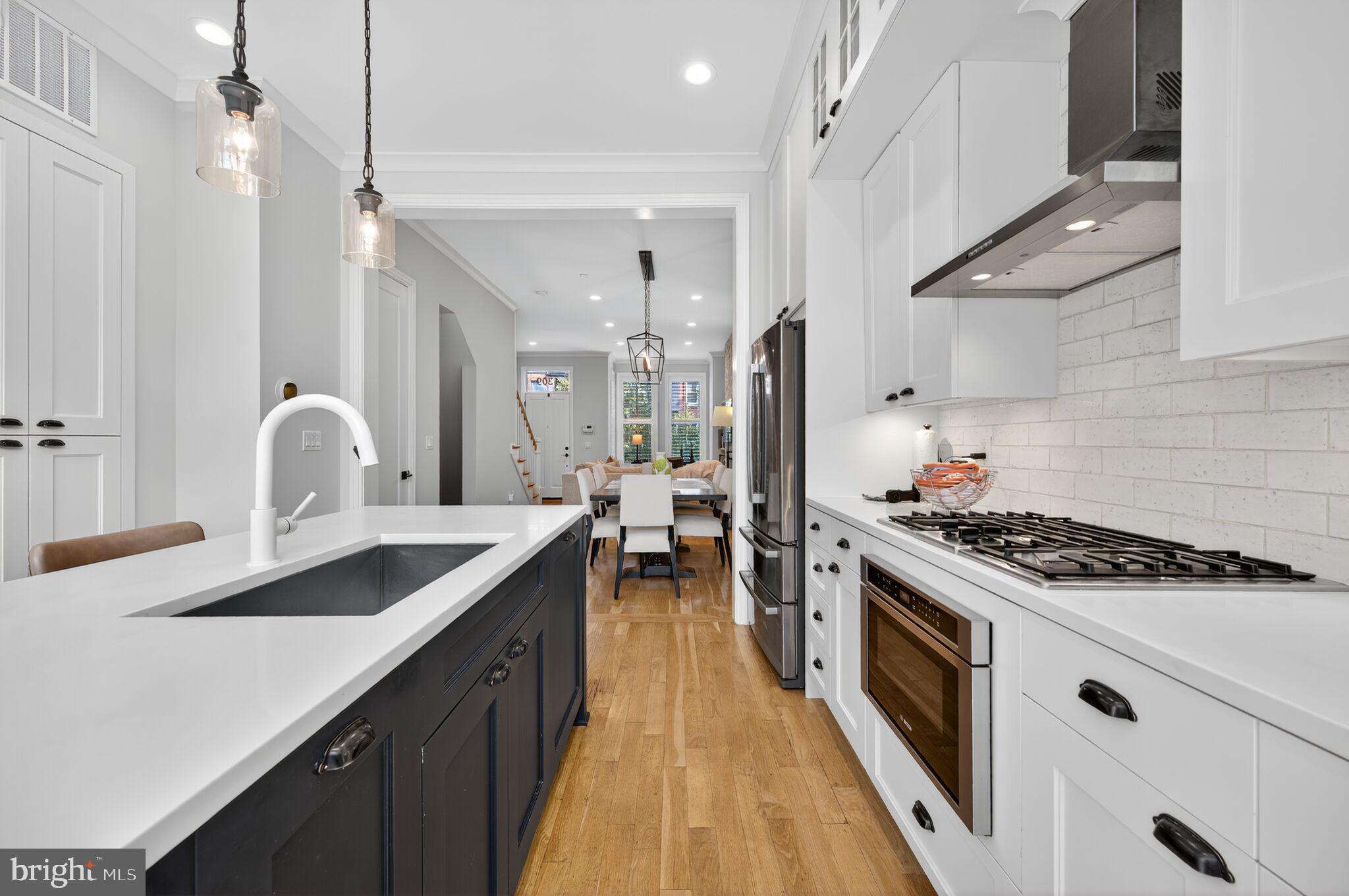 1309 D Street Southeast Washington, DC 20003 - Photo 10 of 38 a kitchen with a sink stove and cabinets