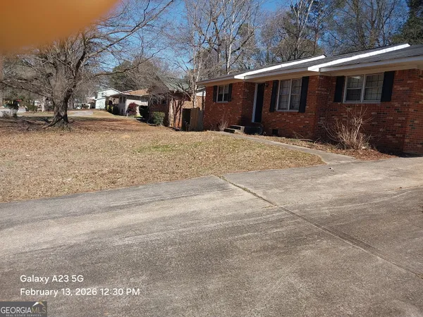 a front view of house with yard covered in snow