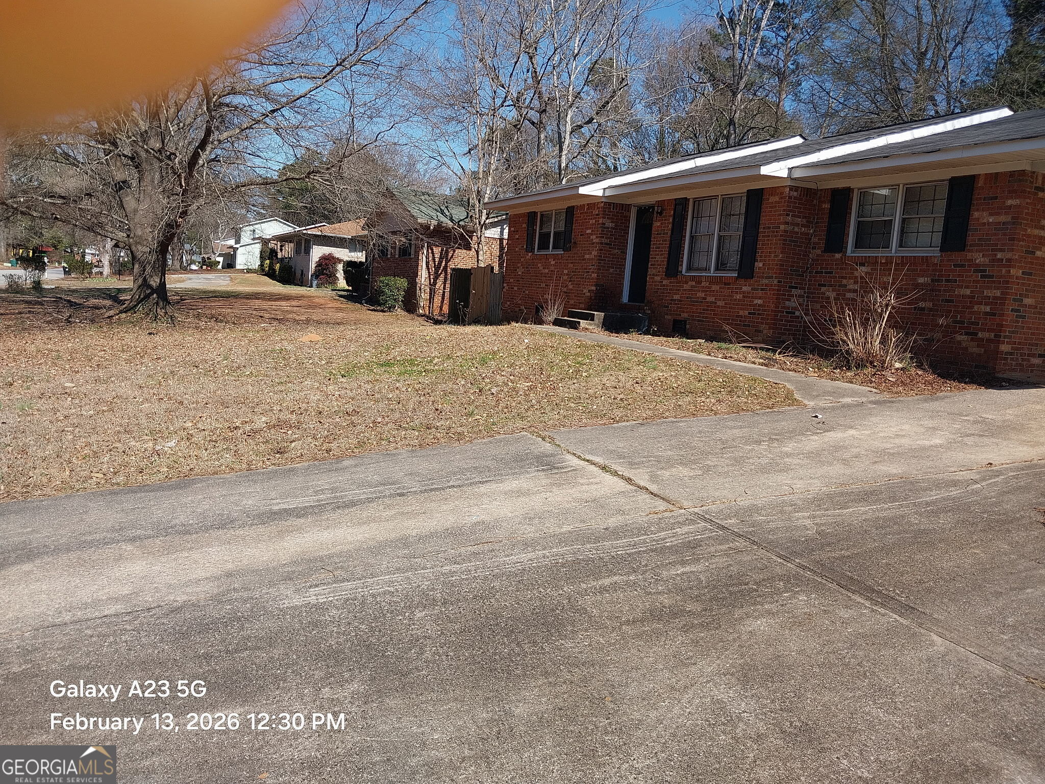 a front view of house with yard covered in snow