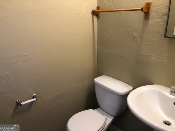 a white toilet sitting next to a bathroom sink