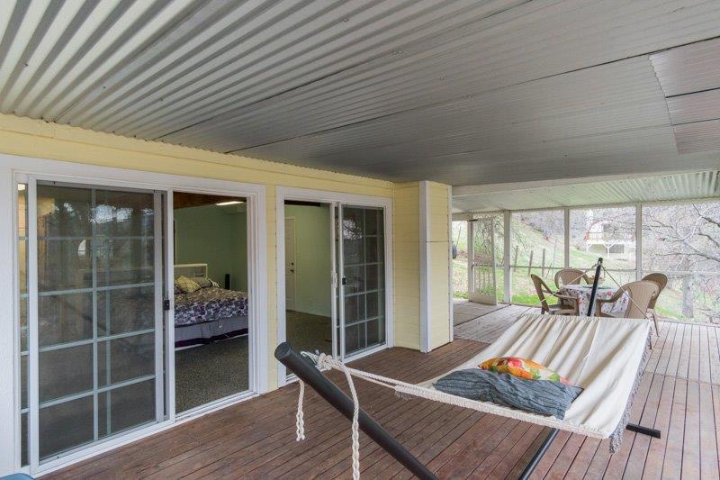 45852 Mineral King Road Three Rivers, CA 93271 - Photo 24 of 36 a balcony with furniture and wooden floor