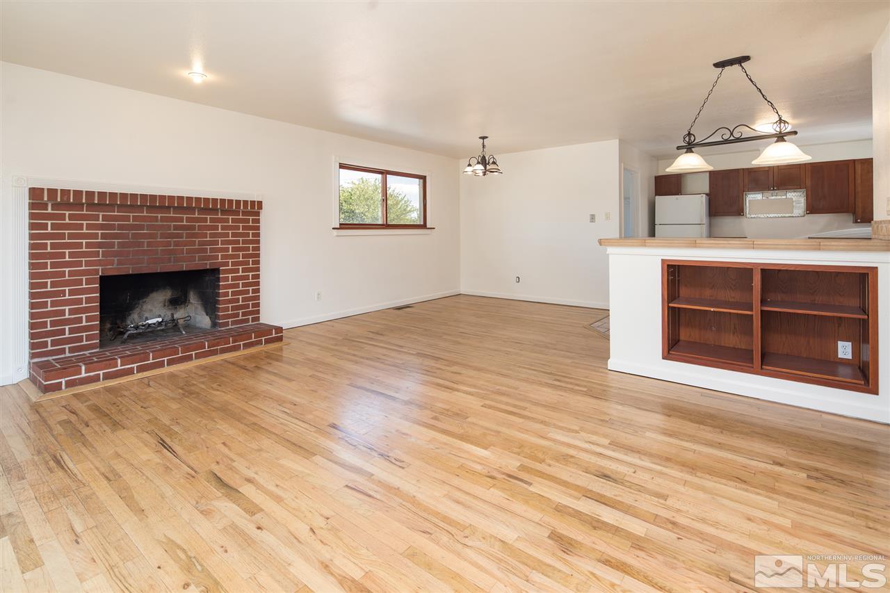 3301 Bryan Street Reno, NV 89503 - Photo 8 of 25 a view of empty room with a fireplace and wooden floor