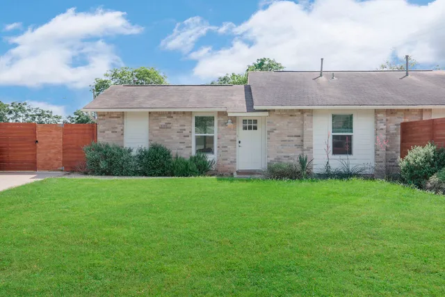 a view of a house with garden and yard
