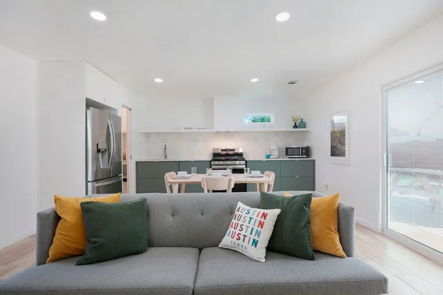 a living room with furniture and kitchen view