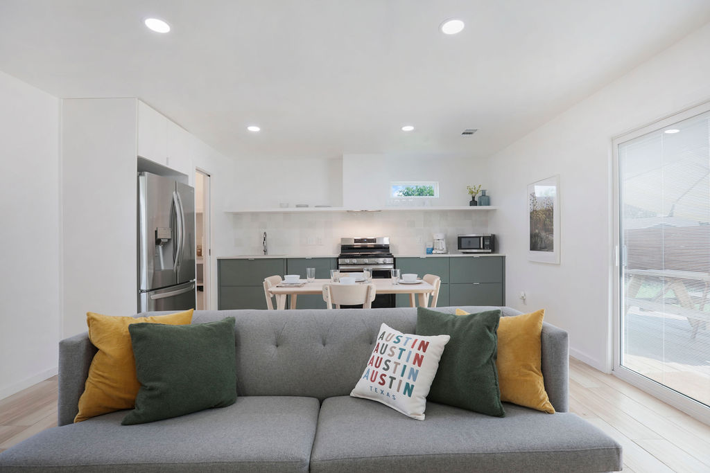 906 East Leslie Circle, Unit A Austin, TX 78721 - Photo 11 of 16 a living room with furniture and kitchen view