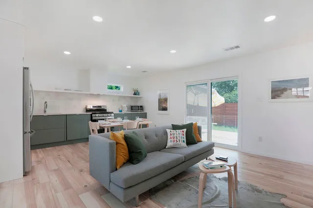 a view of kitchen with kitchen island microwave and cabinets